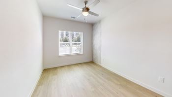 Empty bedroom with ceiling fan and window blinds 1